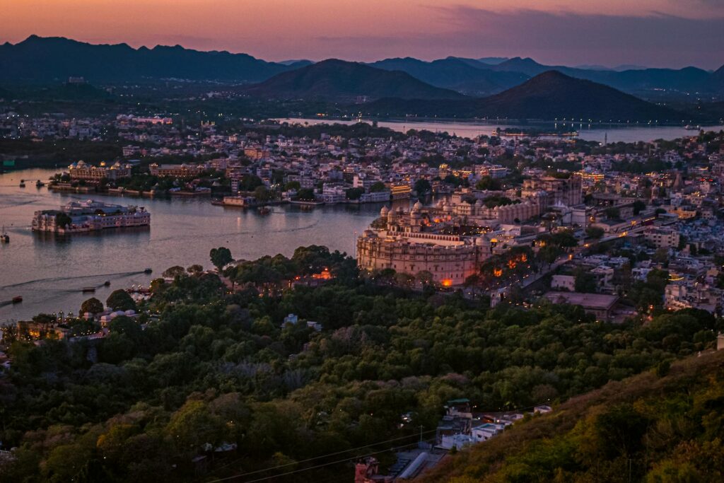Udaipur city skyline during sunset with Lake Pichola and City Palace, Rajasthan, India